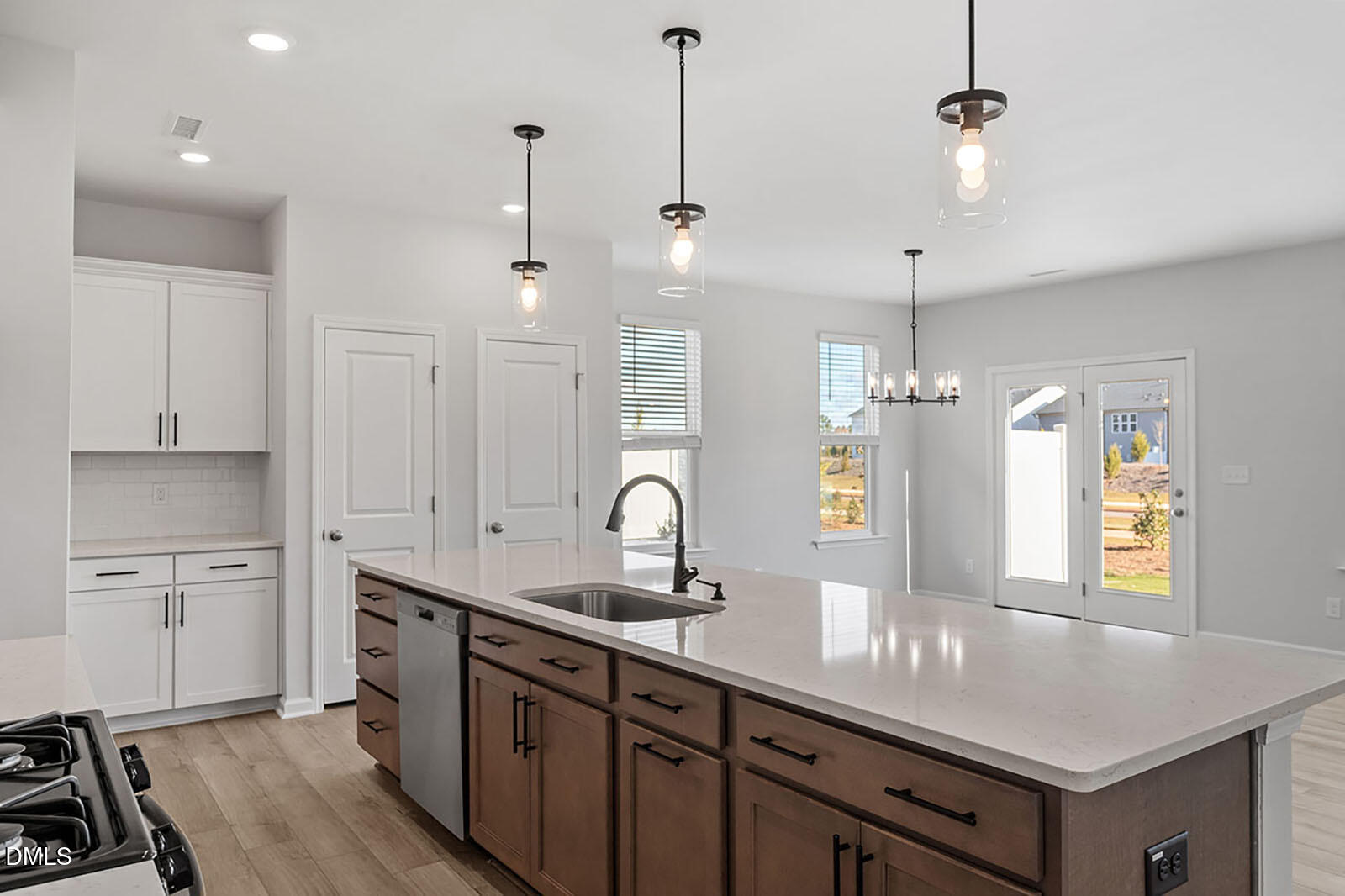 931 Westerland Way, Unit 74 Durham, NC 27703 - Photo 4 of 33 a kitchen with a sink chandelier and wooden floor