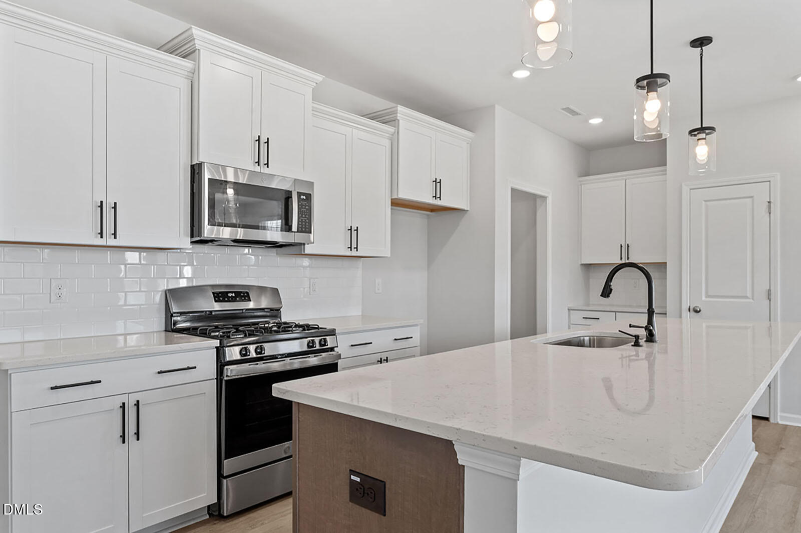 931 Westerland Way, Unit 74 Durham, NC 27703 - Photo 5 of 33 a kitchen with kitchen island a sink stainless steel appliances and cabinets