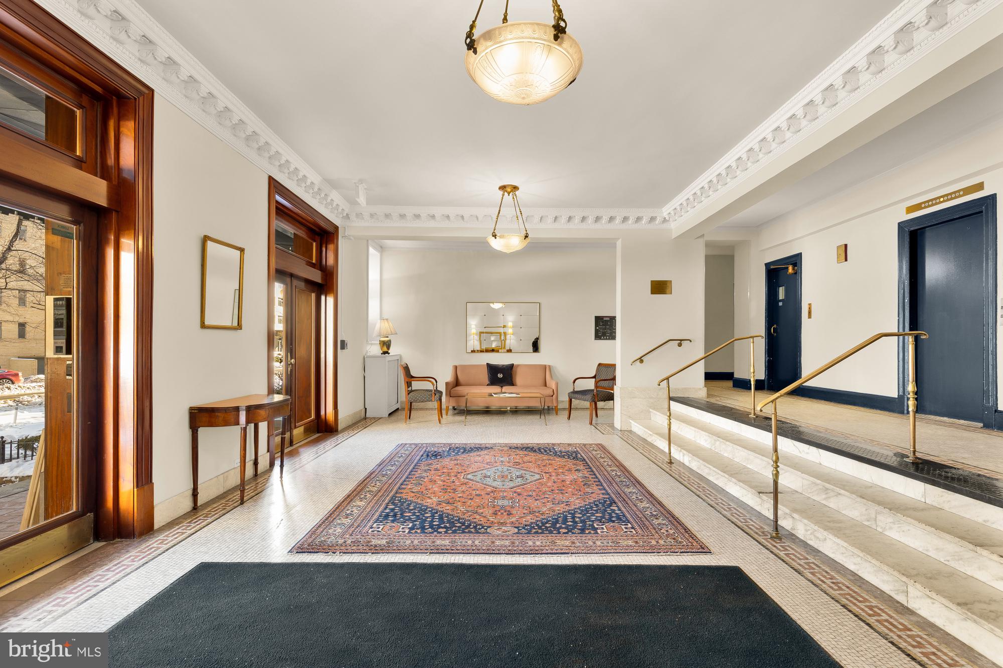 1901 Columbia Road Northwest, Unit 601 Washington, DC 20009 - Photo 3 of 15 a living room with furniture a chandelier and a rug