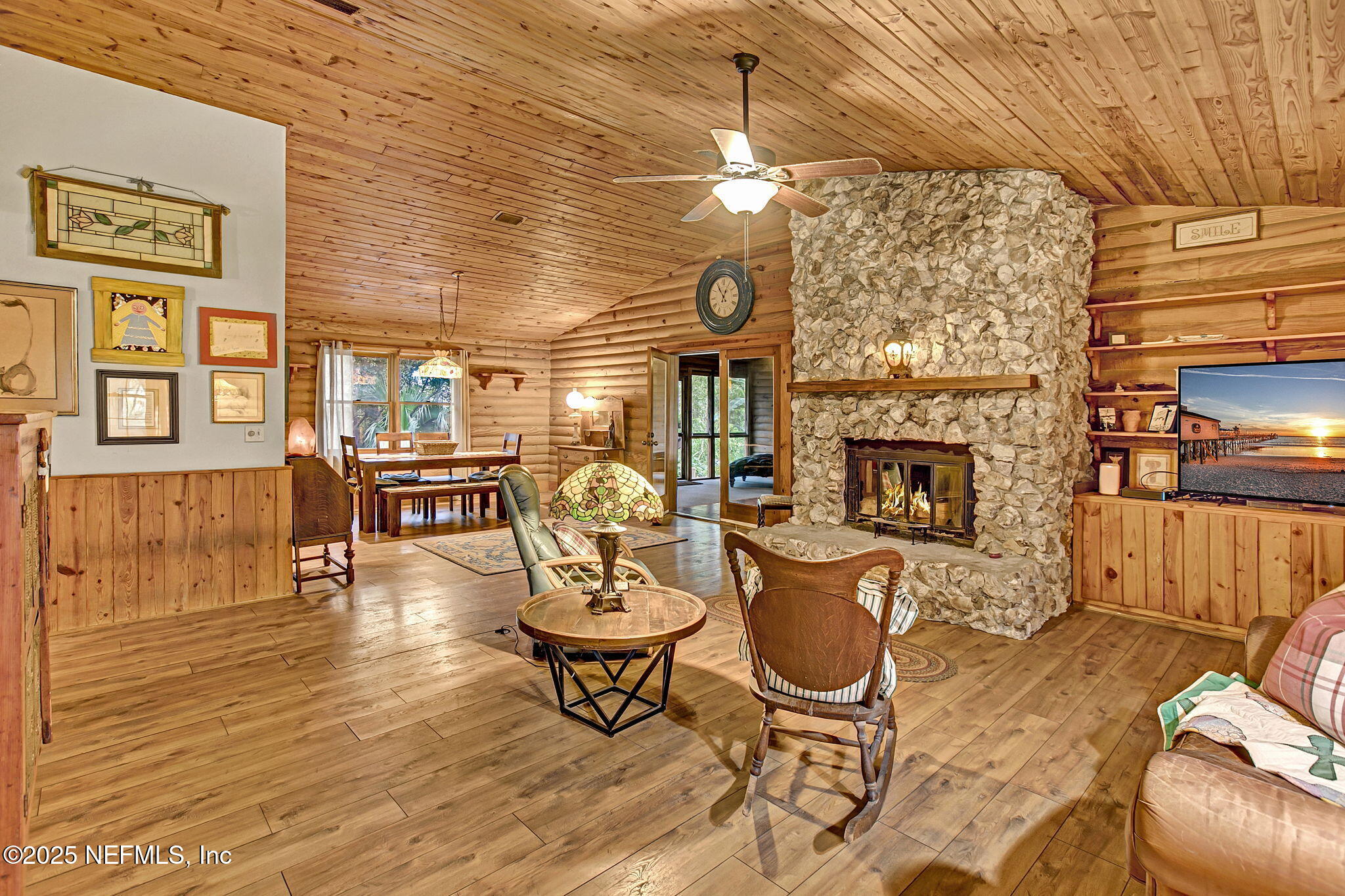 a living room with fireplace furniture and a wooden floor