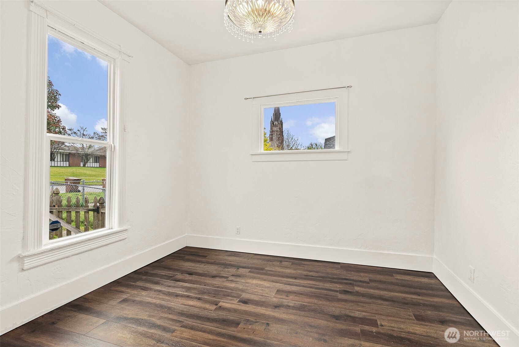409 South 30th Street Tacoma, WA 98402 - Photo 16 of 37 a view of an empty room with wooden floor and a window