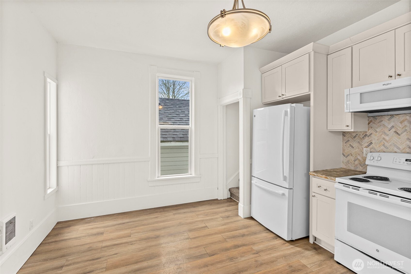 409 South 30th Street Tacoma, WA 98402 - Photo 26 of 37 a kitchen with a refrigerator a stove cabinets and wooden floor