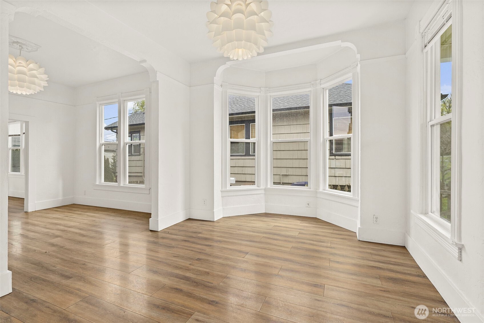 409 South 30th Street Tacoma, WA 98402 - Photo 9 of 37 a view of an empty room with wooden floor and a window