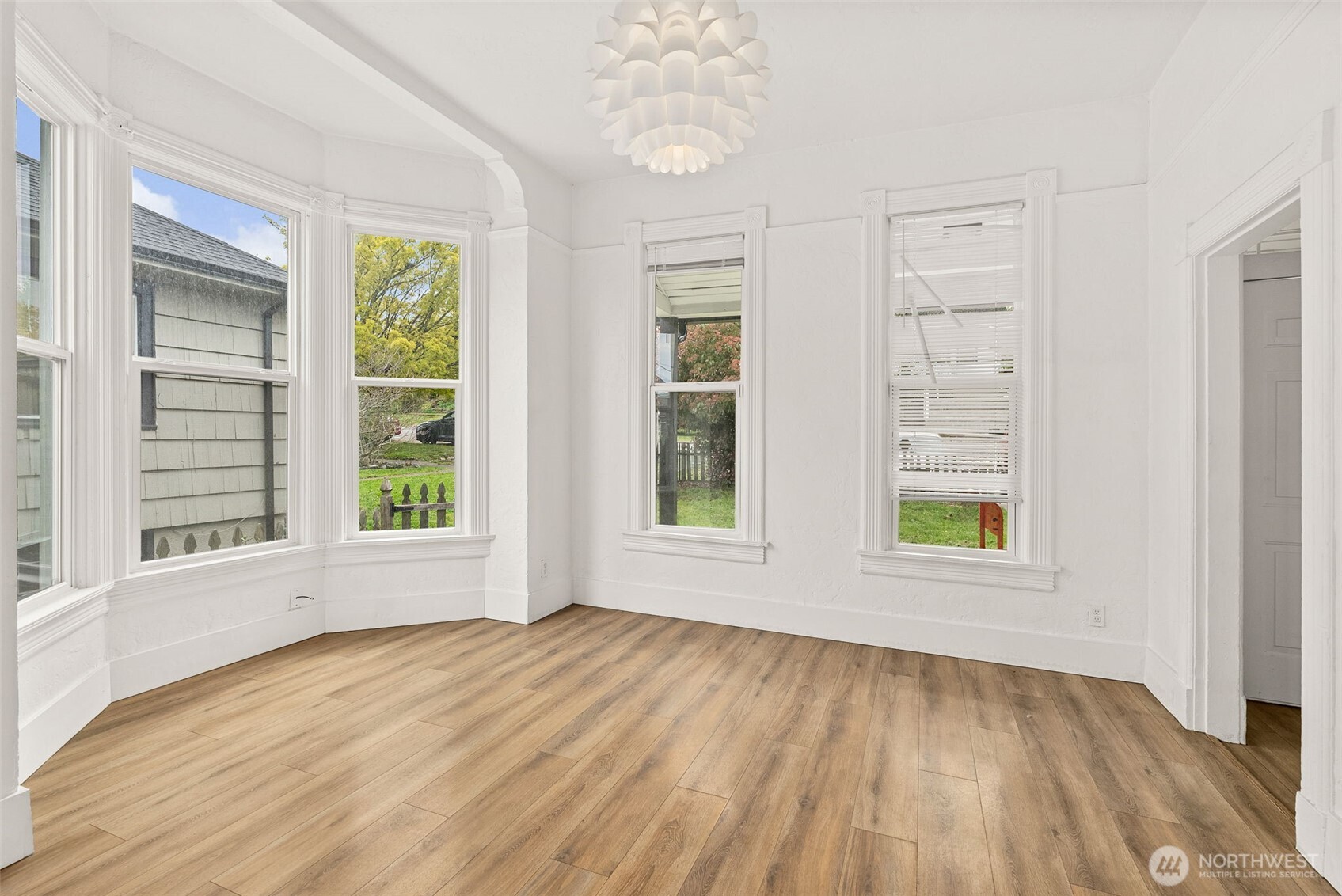 409 South 30th Street Tacoma, WA 98402 - Photo 10 of 37 a view of an empty room with a window and wooden floor