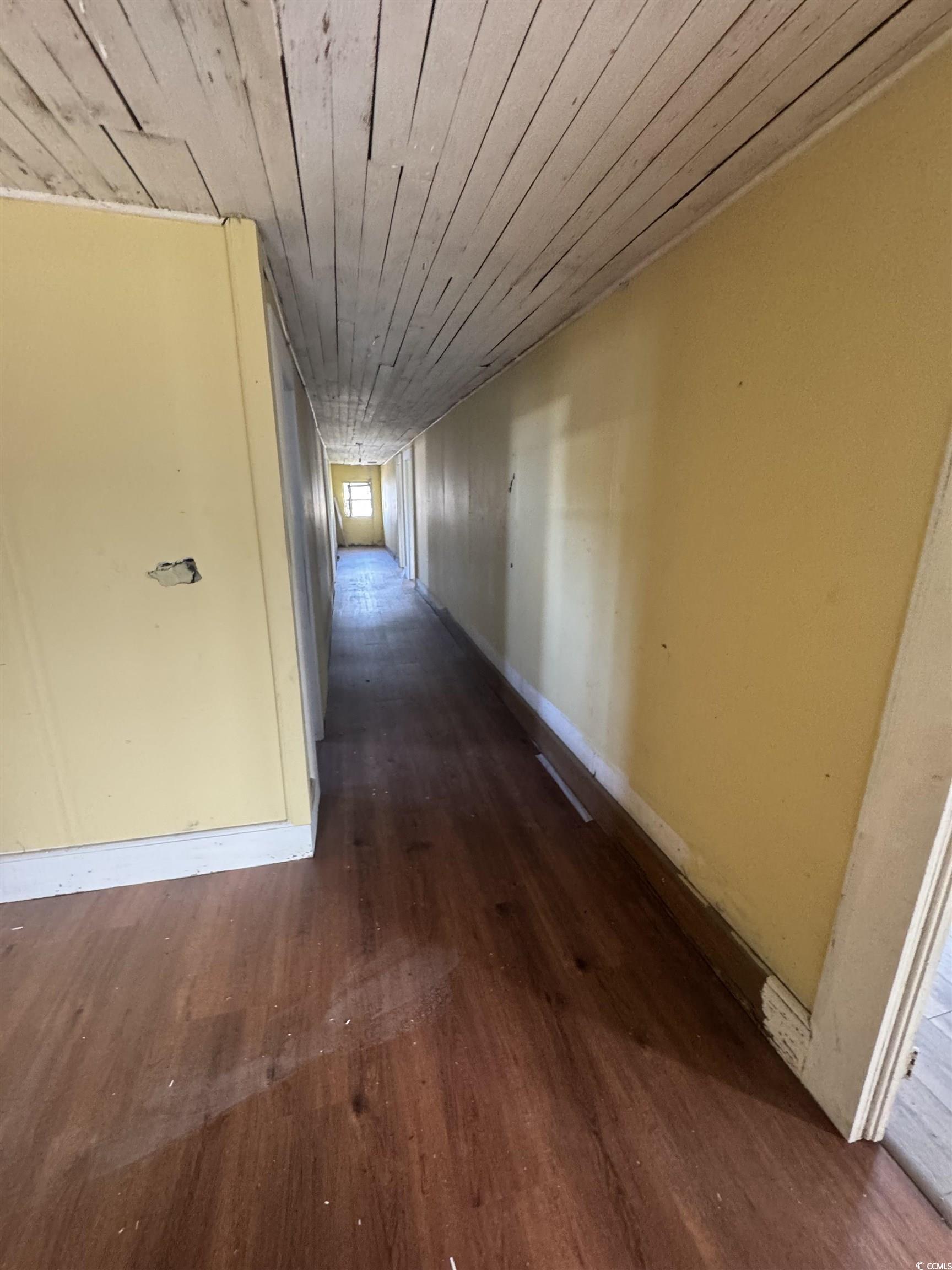 4211 Meeting Street Loris, SC 29569 - Photo 13 of 22 Corridor featuring dark wood-style flooring and wood ceiling