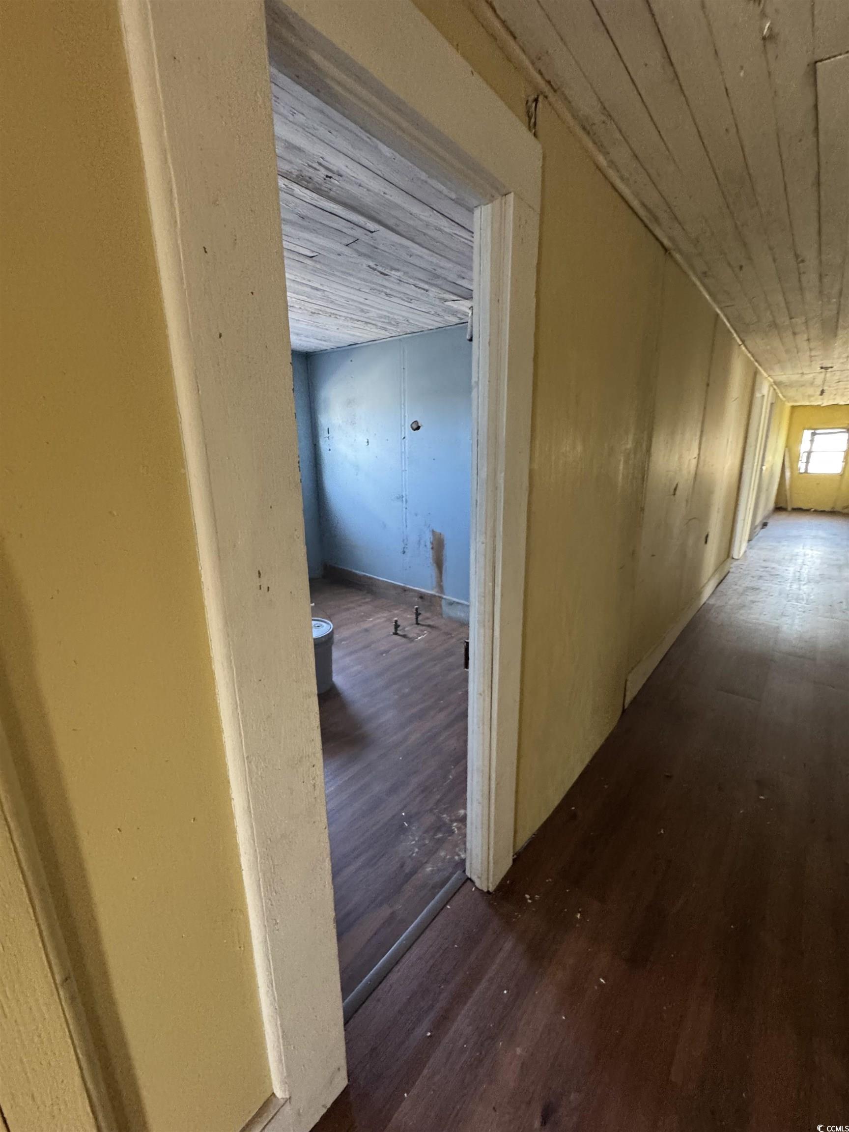 4211 Meeting Street Loris, SC 29569 - Photo 15 of 22 Hallway with dark wood-type flooring and wood ceiling