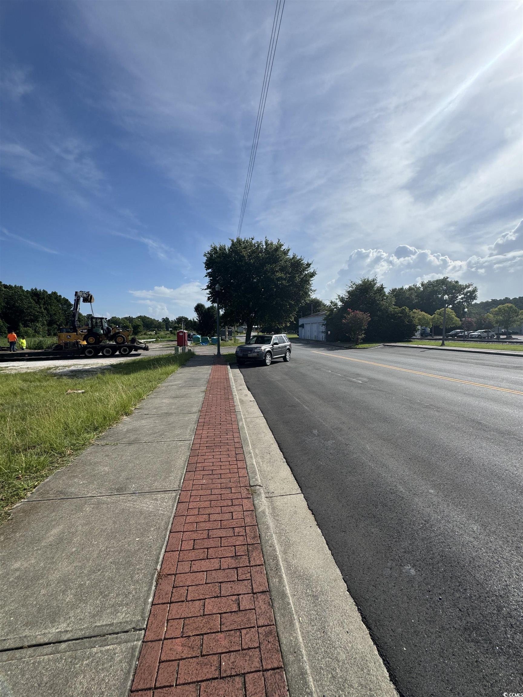 4211 Meeting Street Loris, SC 29569 - Photo 18 of 22 View of asphalt road with sidewalks and curbs