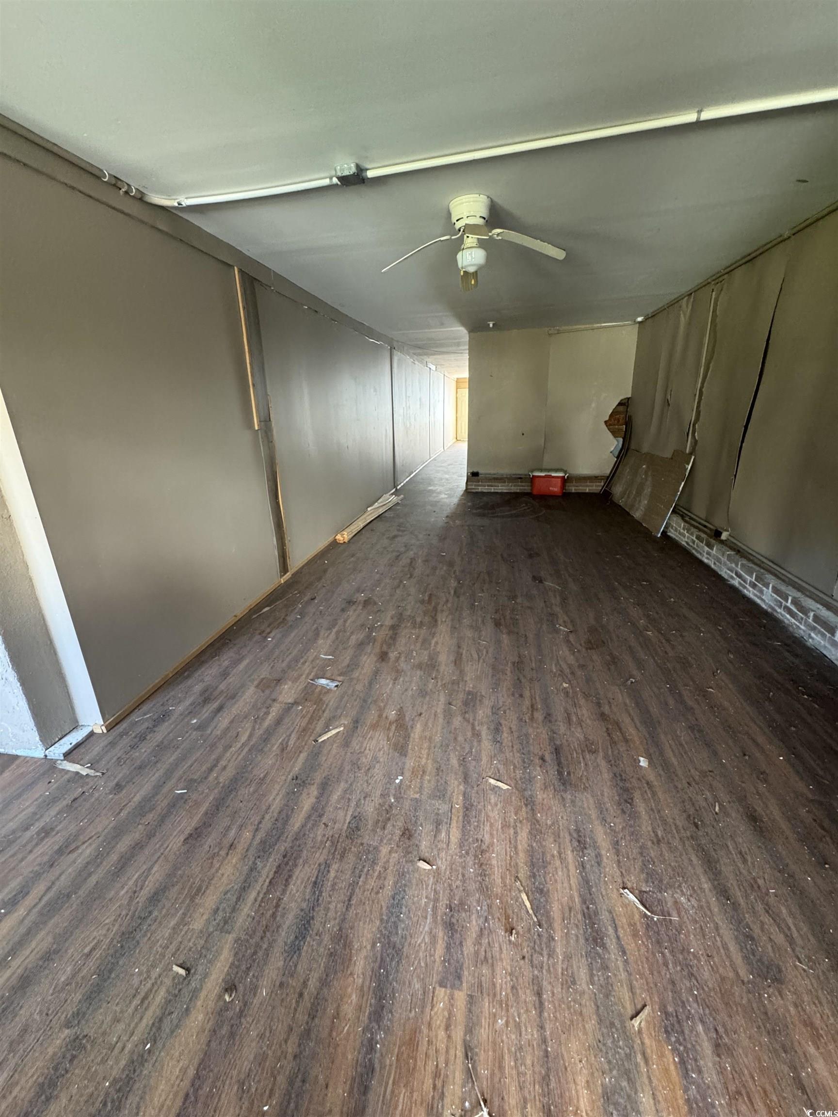 4211 Meeting Street Loris, SC 29569 - Photo 3 of 22 Unfurnished living room featuring dark wood-type flooring and ceiling fan