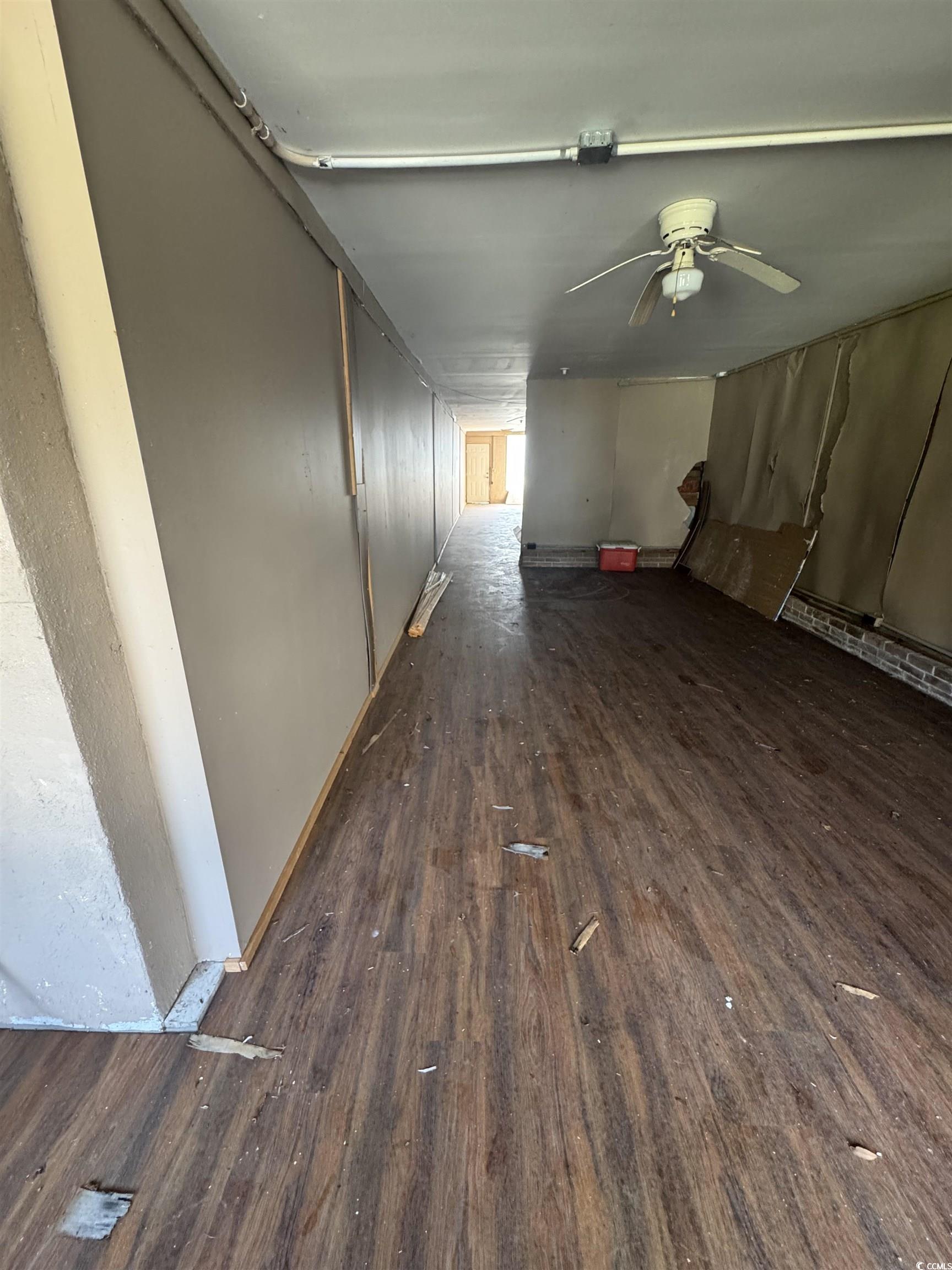4211 Meeting Street Loris, SC 29569 - Photo 4 of 22 Unfurnished living room featuring dark wood-style flooring and a ceiling fan