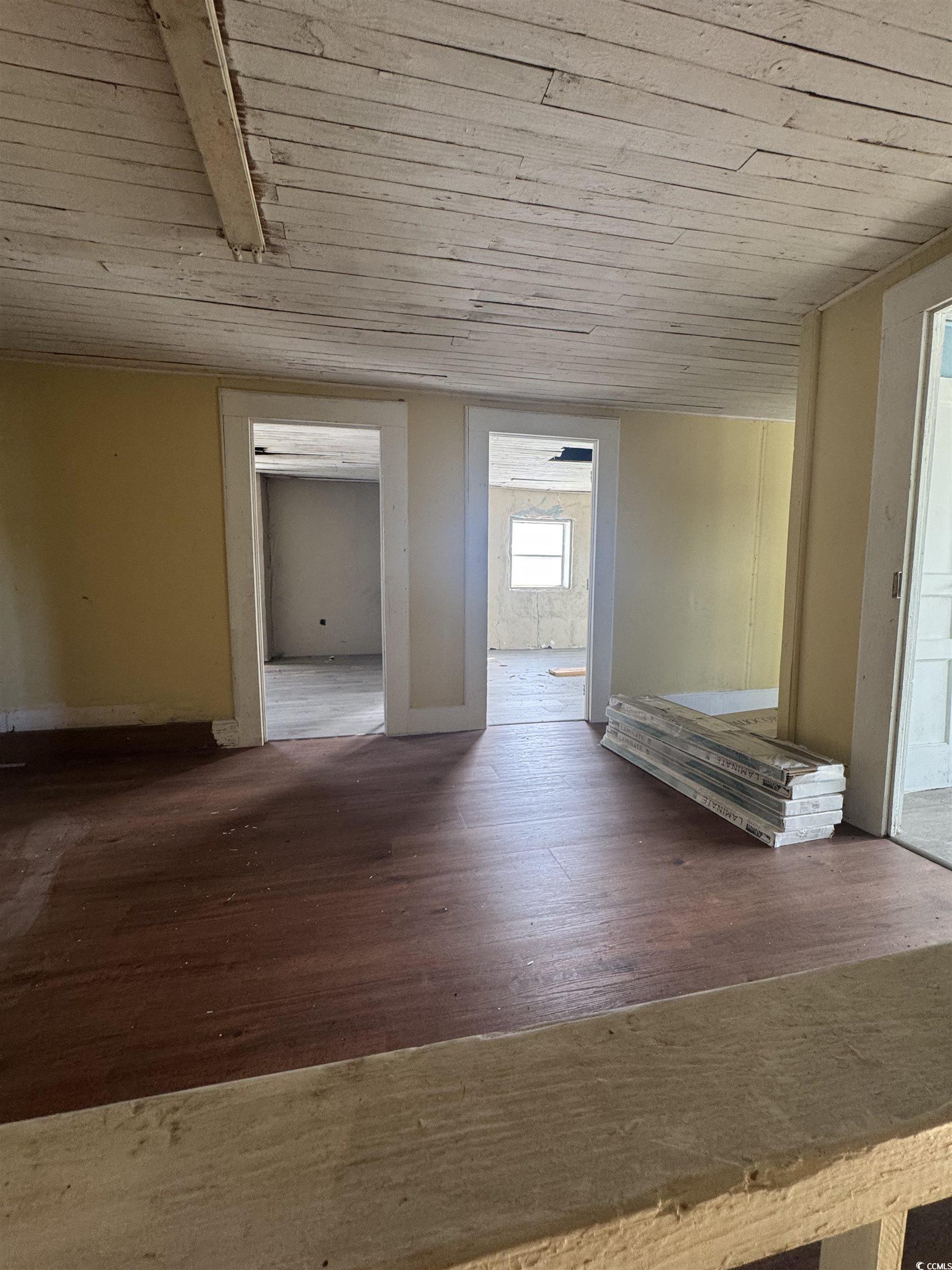 4211 Meeting Street Loris, SC 29569 - Photo 8 of 22 Corridor with dark wood finished floors and wooden ceiling