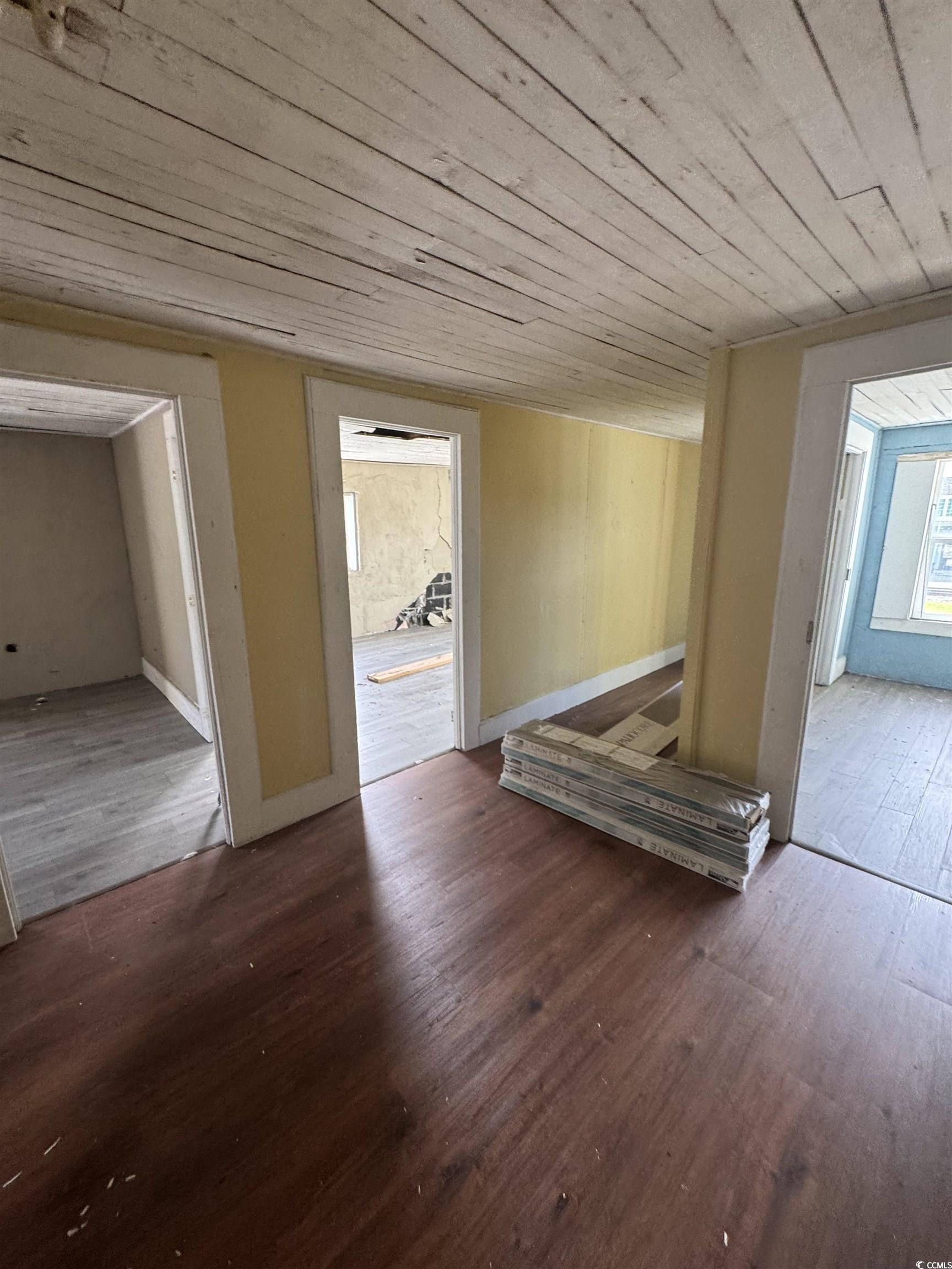4211 Meeting Street Loris, SC 29569 - Photo 10 of 22 Unfurnished living room with dark wood-style flooring and wood ceiling