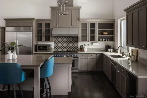 a kitchen with stainless steel appliances kitchen island granite countertop a sink stove and refrigerator