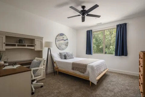 a bed room with a bed and a large window