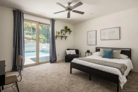 a bedroom with a bed a couch and a window