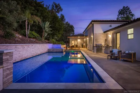 a swimming pool with outdoor seating and yard