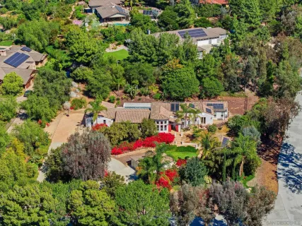 an aerial view of a house with a yard and garden