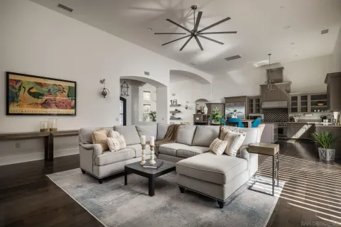 a living room with furniture kitchen view and a table