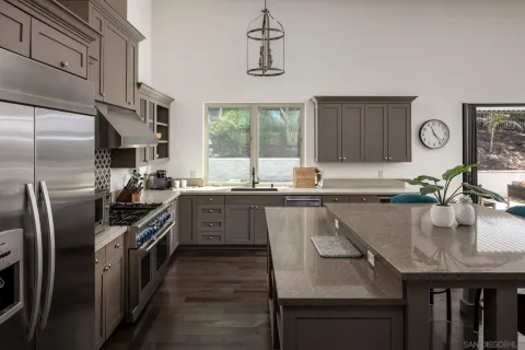a kitchen with stainless steel appliances granite countertop a sink a stove and a refrigerator