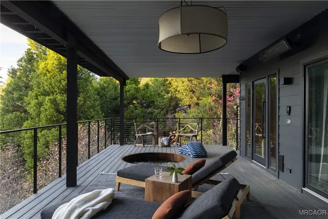 a view of a balcony with chairs and a potted plant