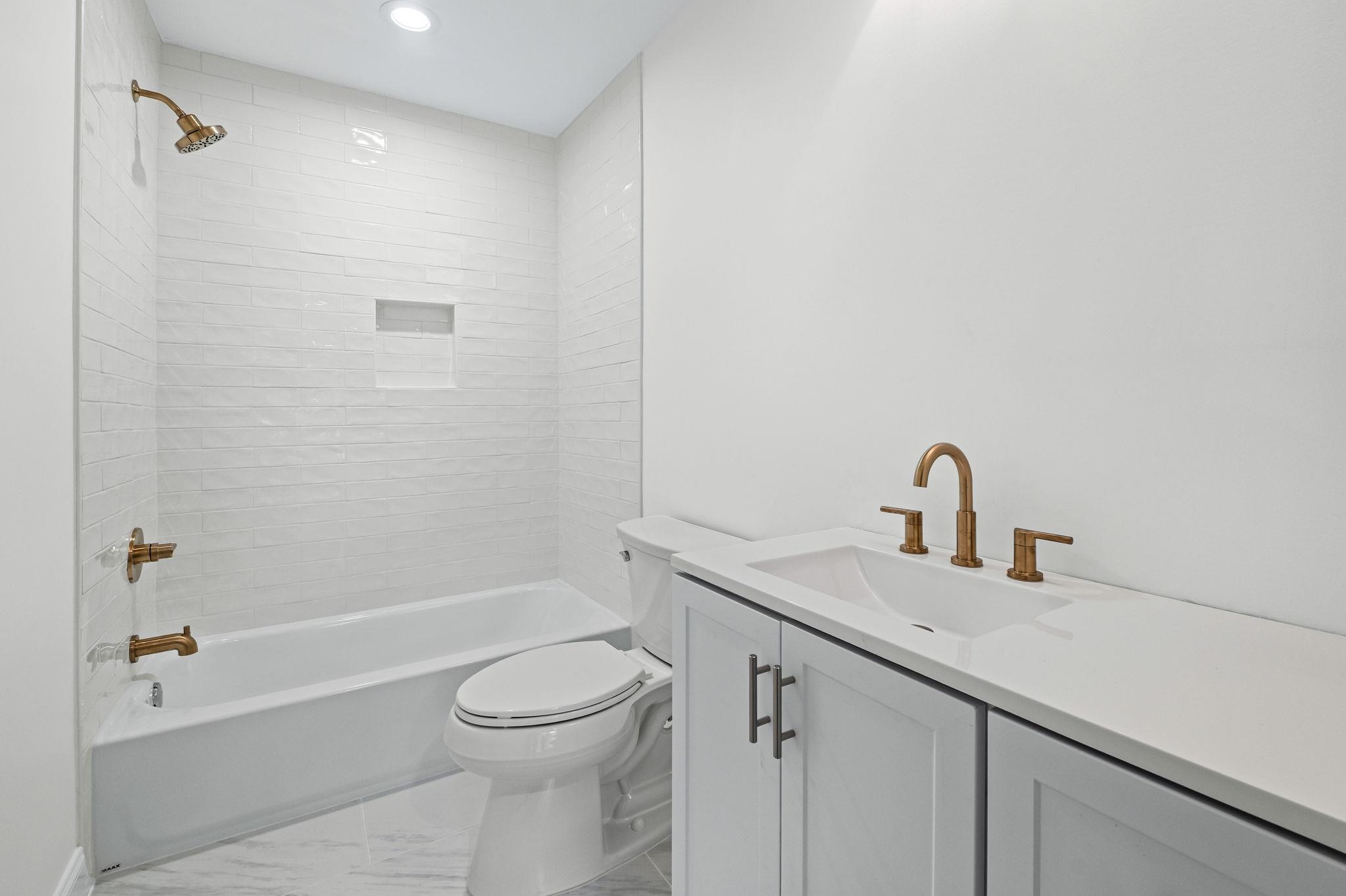 59 Devon Way Memphis, TN 38111 - Photo 24 of 40 a bathroom with a granite countertop sink a toilet and shower