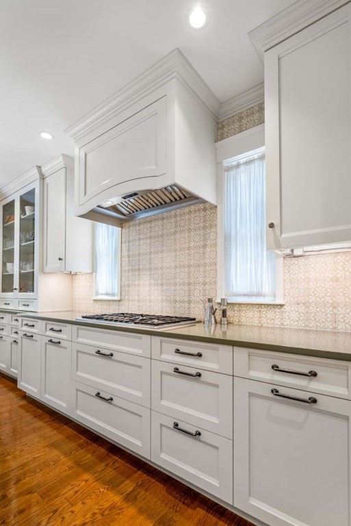 29 Royce Road Newton, MA 02459 - Photo 13 of 38 a kitchen with granite countertop white cabinets and white appliances