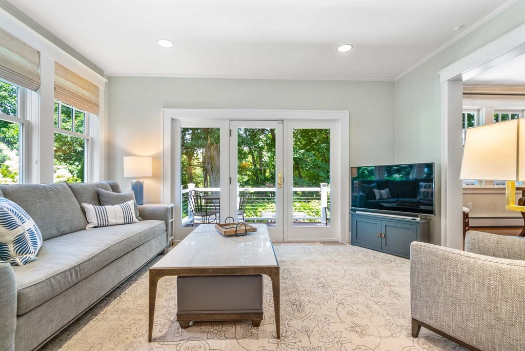 29 Royce Road Newton, MA 02459 - Photo 14 of 38 a living room with furniture large windows and flat screen tv