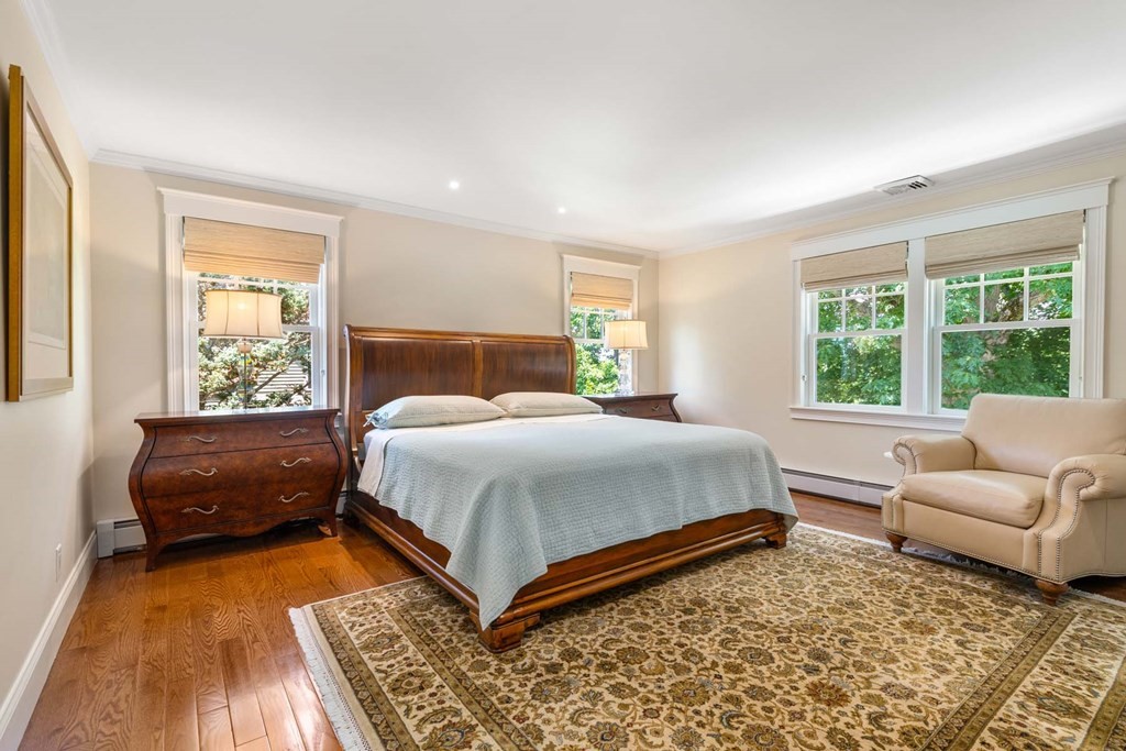 29 Royce Road Newton, MA 02459 - Photo 17 of 38 a bedroom with a bed and a couch next to a window
