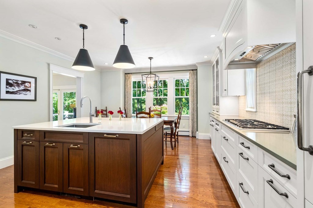 29 Royce Road Newton, MA 02459 - Photo 10 of 38 a kitchen with kitchen island granite countertop a sink and wooden floor