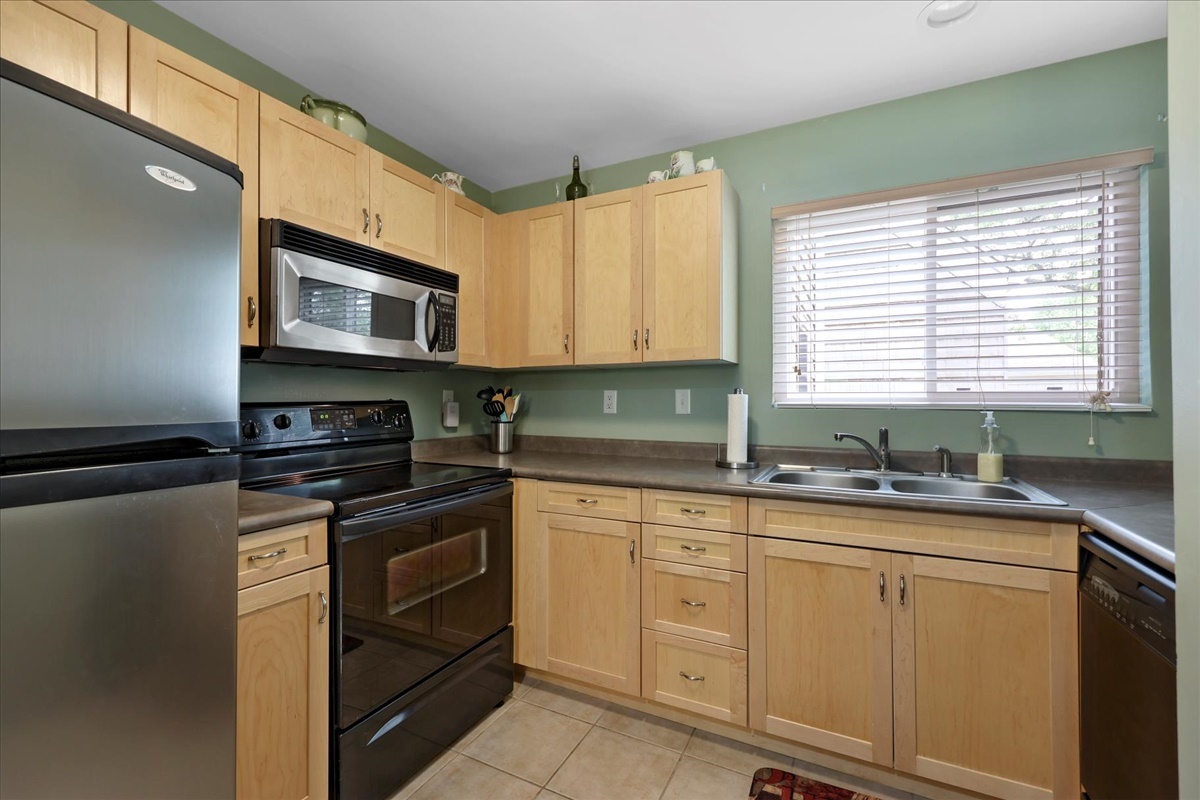 2004 Blackthorn Drive Champaign, IL 61821 - Photo 8 of 24 a kitchen with stainless steel appliances granite countertop a sink and a microwave