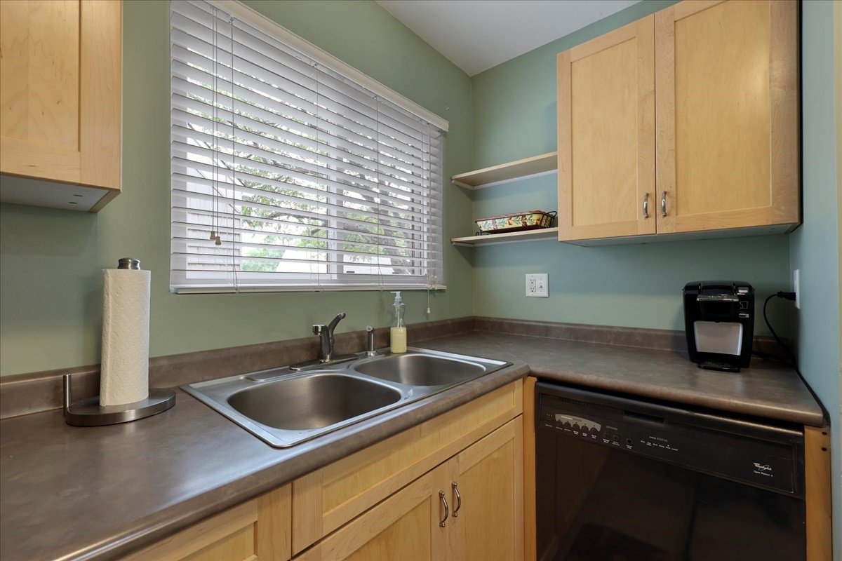 2004 Blackthorn Drive Champaign, IL 61821 - Photo 9 of 24 a kitchen with stainless steel appliances granite countertop a sink a microwave cabinets and a window