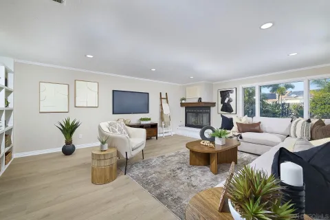 a living room with fireplace furniture and a large window
