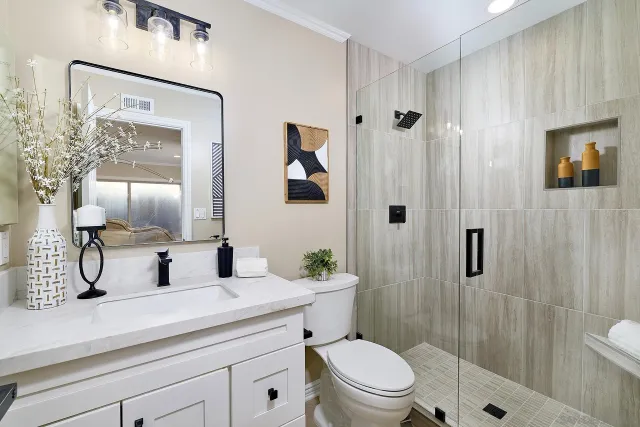 a bathroom with a toilet a sink and shower