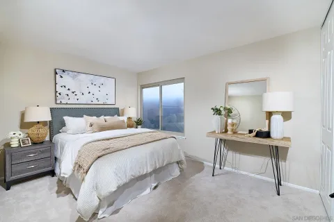 a bedroom with a bed and a table in it