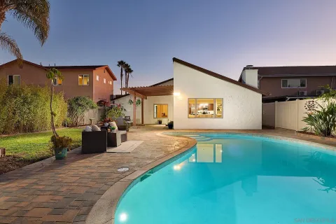 a swimming pool view with a outdoor seating space