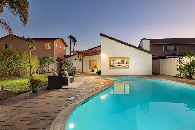 a swimming pool view with a outdoor seating space