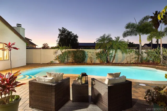 a view of a swimming pool and lounge chairs