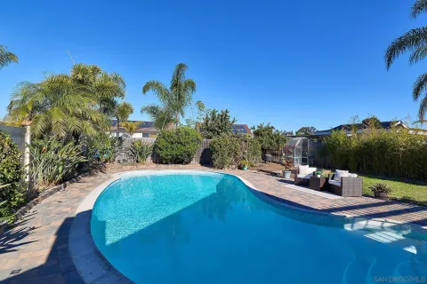 a view of a swimming pool with a yard
