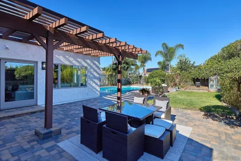 a view of a patio with a table and chairs
