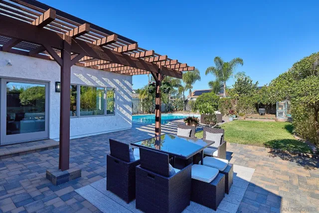 a view of a patio with a table and chairs