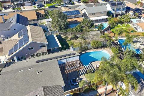 an aerial view of a residential houses with outdoor space and street view