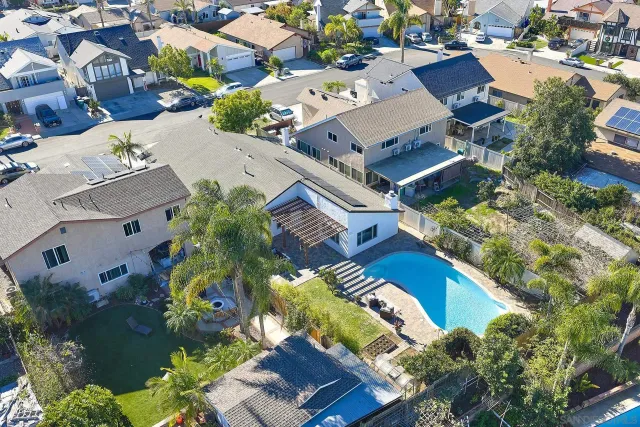 an aerial view of a house with a yard