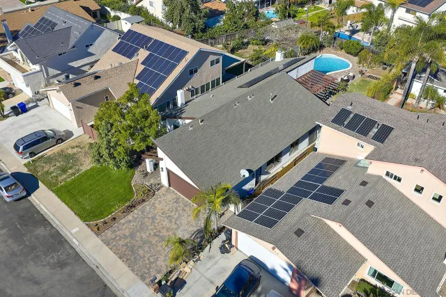 an aerial view of a house with a yard