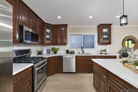a kitchen with a sink cabinets and stainless steel appliances
