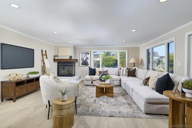 a living room with fireplace furniture and a flat screen tv