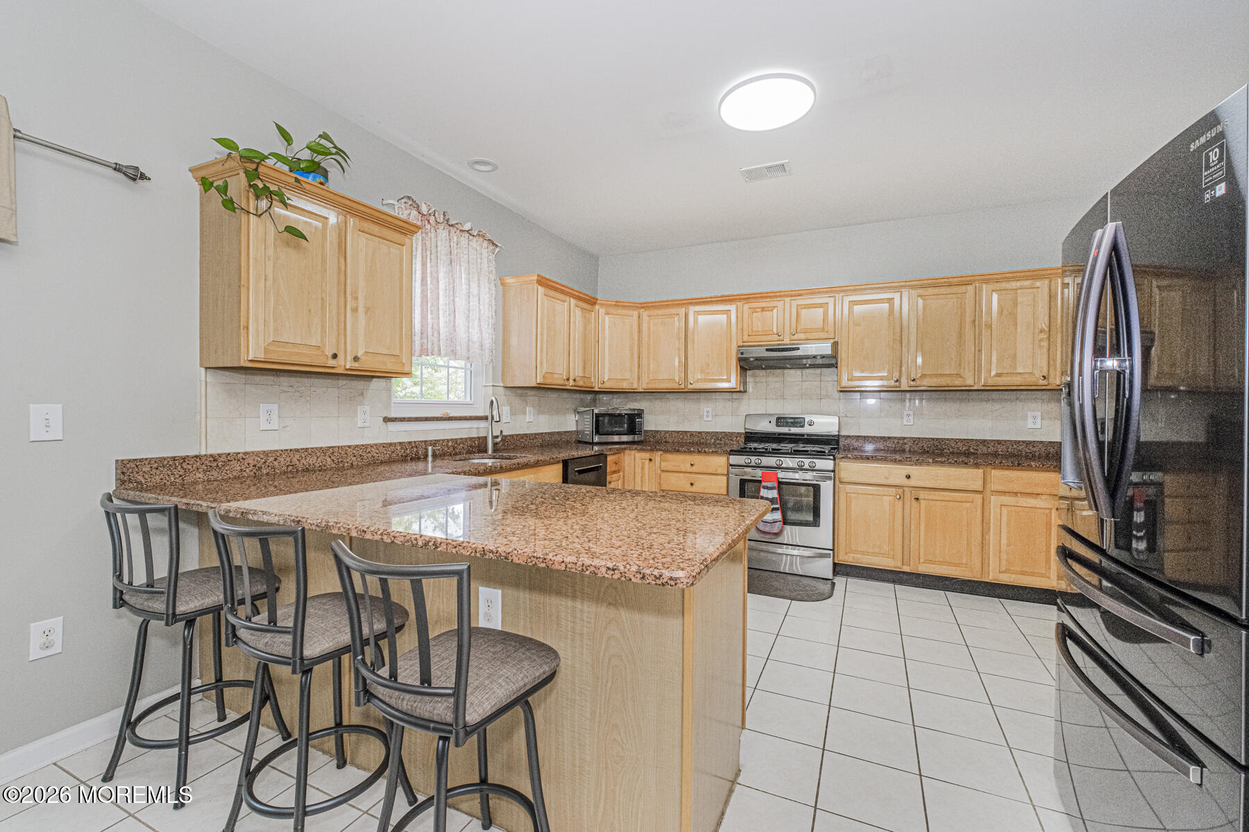 315 Wedgewood Road Morganville, NJ 07751 - Photo 14 of 37 a kitchen with a stove a sink and a refrigerator