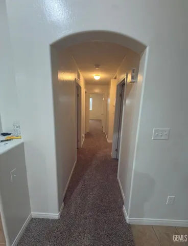 a kitchen with kitchen island a sink and refrigerator