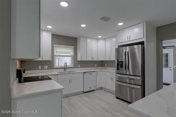 a kitchen with refrigerator cabinets and stainless steel appliances