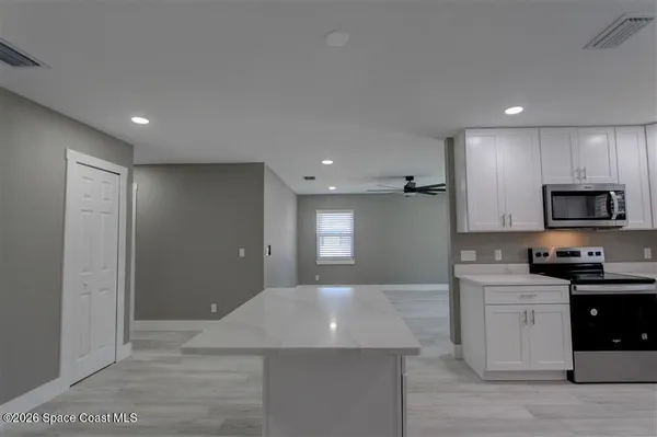 a kitchen with stainless steel appliances granite countertop a sink a stove and a refrigerator