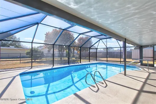 a view of a swimming pool with a lounge chair