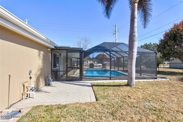 a view of a house with backyard porch and sitting area